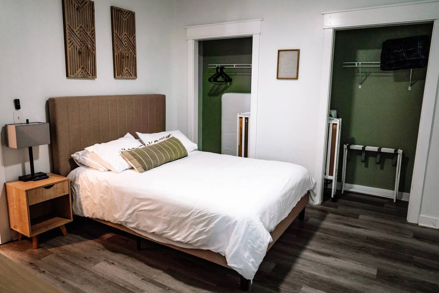 Queen bed in a bright bedroom with ceiling fan and Roku TV
